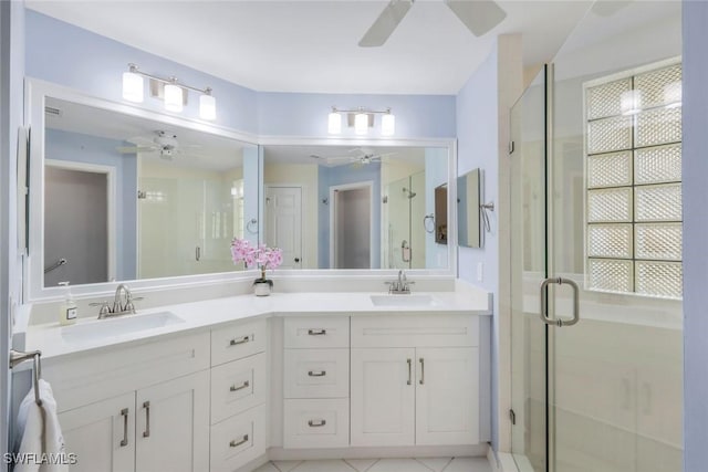 77 Silver Oaks Cir Unit 8-104, Naples, FL 34119 - bathroom featuring a ceiling fan, a shower stall, and double vanity