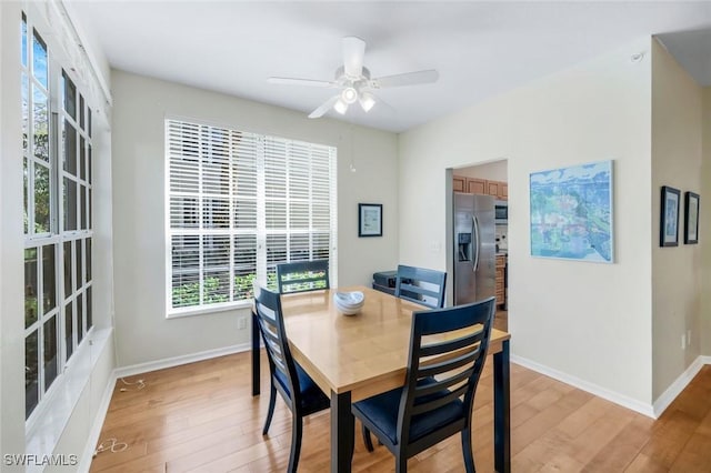 dining area featuring baseboards, light wood-type flooring, and ceiling fan