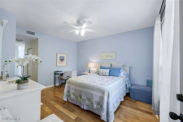77 Silver Oaks Cir Unit 8-104, Naples, FL 34119 - bedroom with light wood finished floors, a ceiling fan, and baseboards