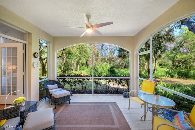 sunroom featuring ceiling fan