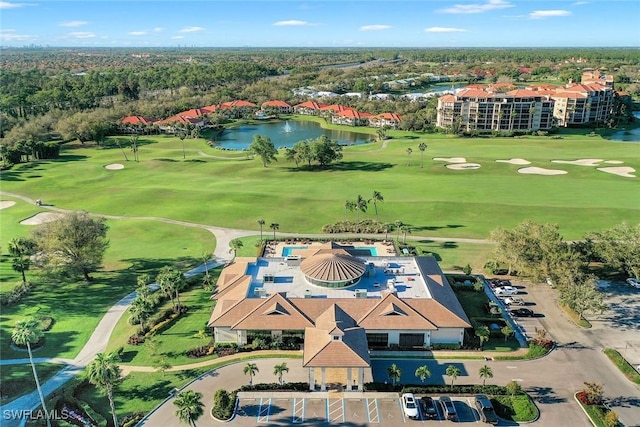 aerial view with golf course view and a water view