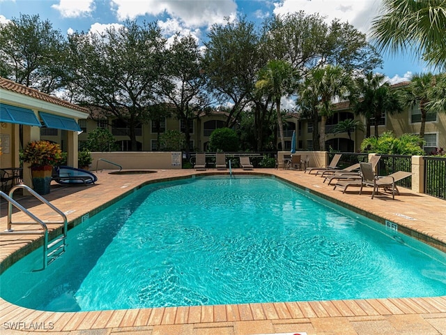 pool featuring a patio and fence