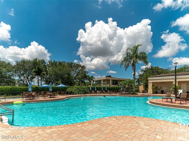 77 Silver Oaks Cir Unit 8-104, Naples, FL 34119 - community pool featuring a patio area