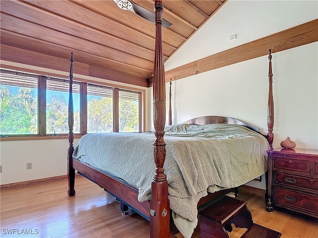 bedroom featuring vaulted ceiling, multiple windows, wooden ceiling, and wood finished floors