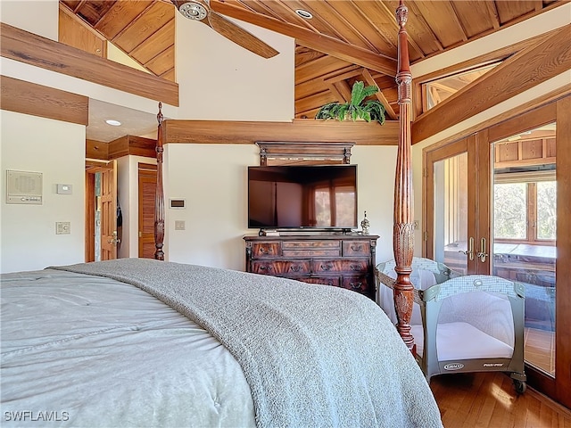 bedroom featuring high vaulted ceiling and wood finished floors