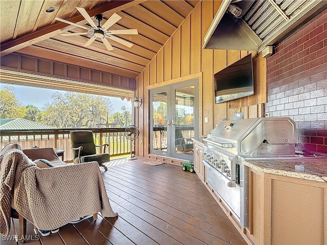 wooden terrace featuring ceiling fan, grilling area, exterior kitchen, and french doors