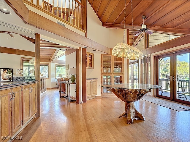 interior space featuring french doors, ceiling fan, high vaulted ceiling, light wood-type flooring, and wooden ceiling