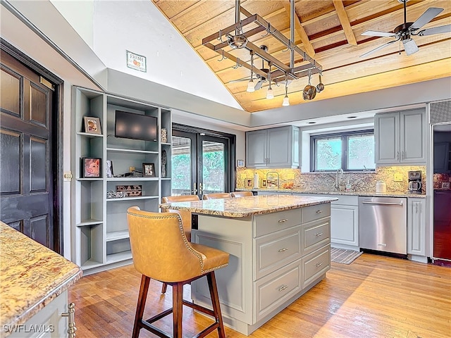 kitchen featuring dishwasher, wooden ceiling, light wood-style flooring, ceiling fan, and a center island