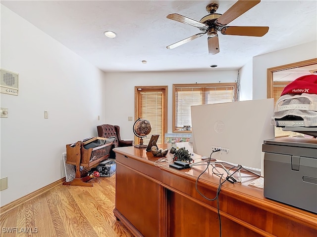 office featuring ceiling fan, light wood-style flooring, and baseboards