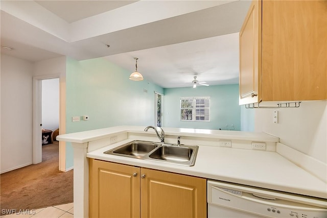kitchen with light brown cabinets, light colored carpet, dishwasher, light countertops, and a sink