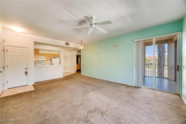 unfurnished living room with visible vents, a ceiling fan, and carpet