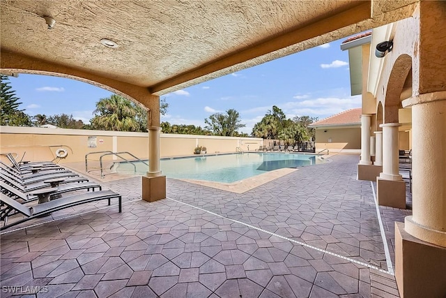 pool with a patio area