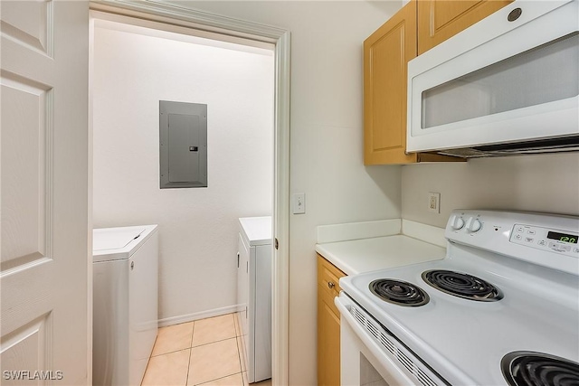 kitchen featuring light countertops, electric panel, light tile patterned floors, washer and dryer, and white appliances