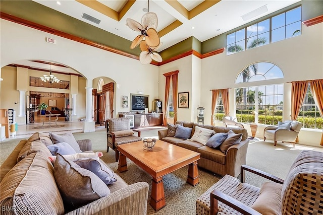 living area with carpet flooring, decorative columns, visible vents, and arched walkways