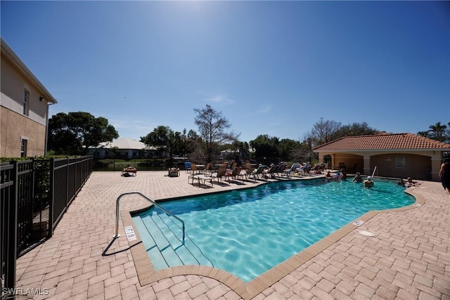 community pool featuring a patio and fence