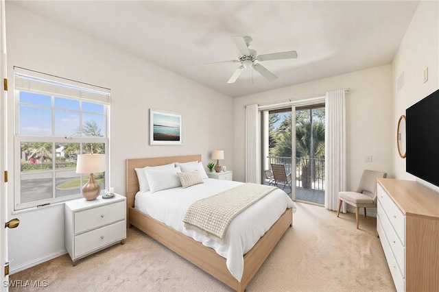 bedroom featuring access to exterior, multiple windows, light carpet, and ceiling fan