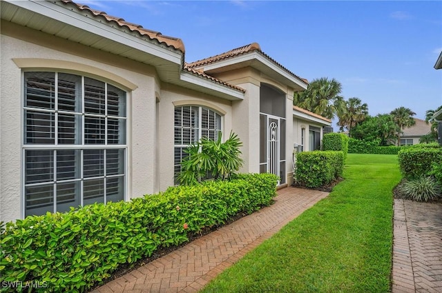 view of property exterior featuring a lawn