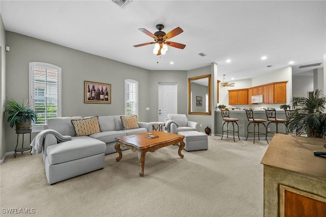 living room with ceiling fan and light colored carpet