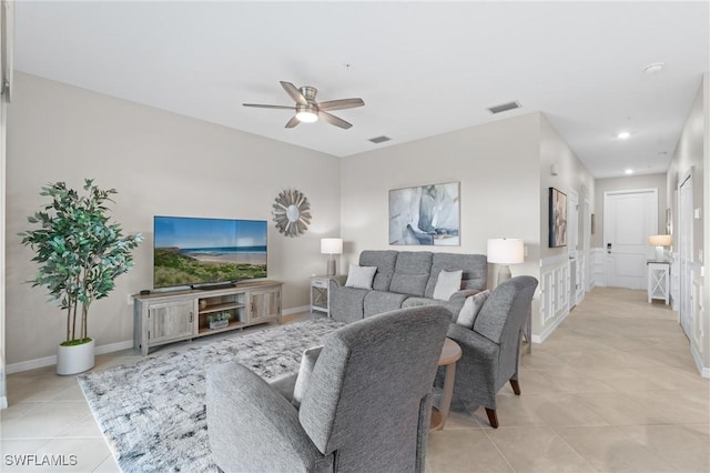 living area featuring light tile patterned floors, baseboards, and visible vents