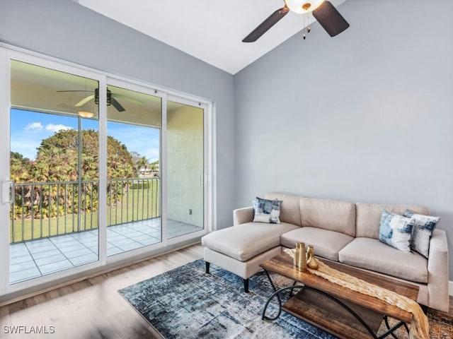 living room featuring lofted ceiling, a ceiling fan, and wood finished floors