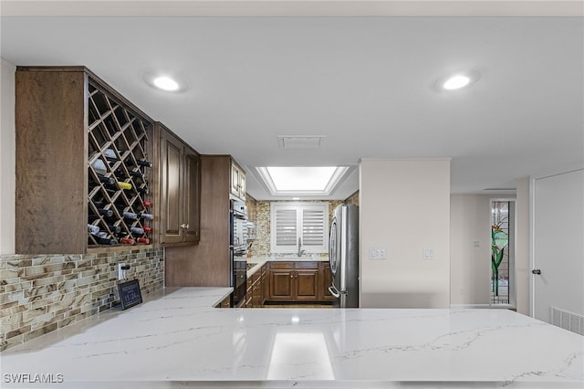 interior space with a skylight, a sink, visible vents, and recessed lighting