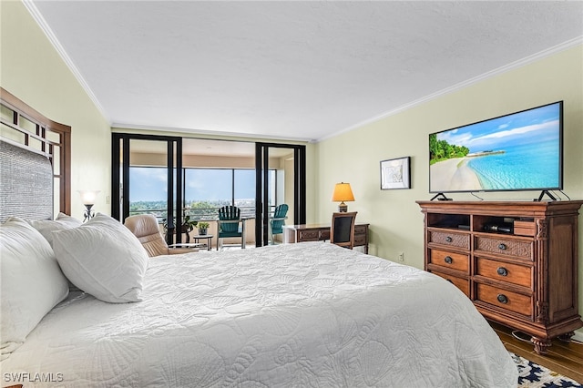 bedroom featuring access to outside, crown molding, and wood finished floors