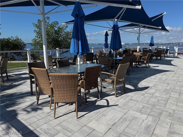 view of patio featuring outdoor dining area and a water view