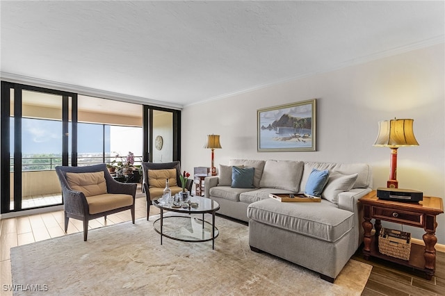 living area featuring ornamental molding, floor to ceiling windows, and wood finished floors