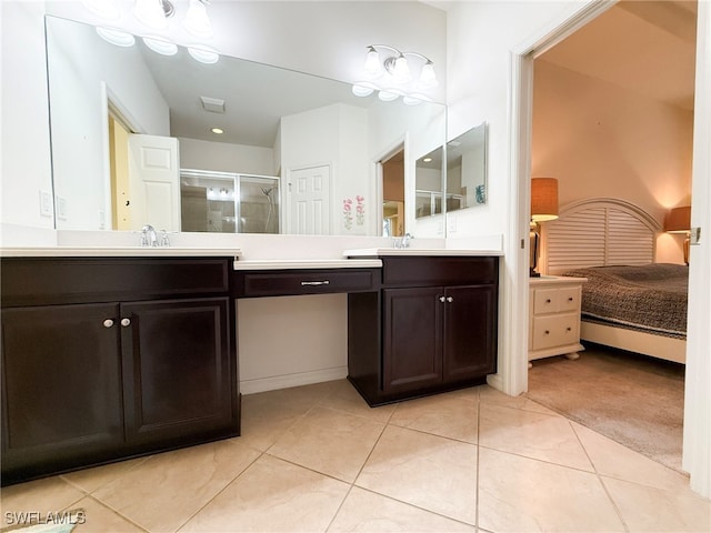 ensuite bathroom featuring ensuite bath, a shower stall, vanity, and tile patterned floors