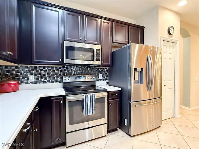 kitchen with appliances with stainless steel finishes, light countertops, and light tile patterned flooring