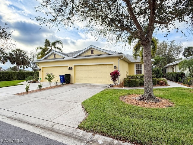 single story home with an attached garage, a front yard, concrete driveway, and stucco siding