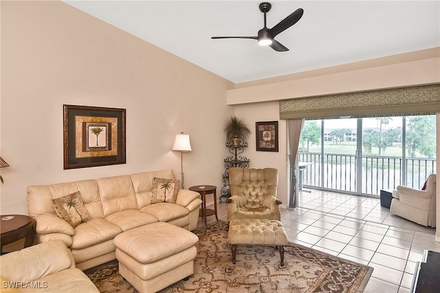 tiled living area featuring lofted ceiling and a ceiling fan