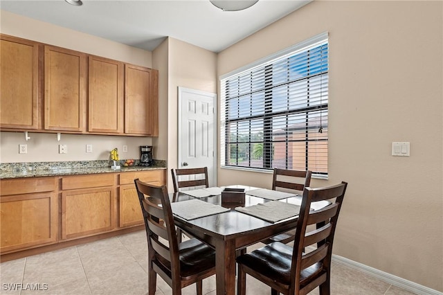 dining room with baseboards and light tile patterned floors