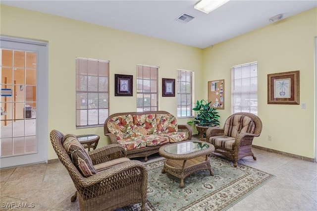 tiled living area with visible vents and baseboards