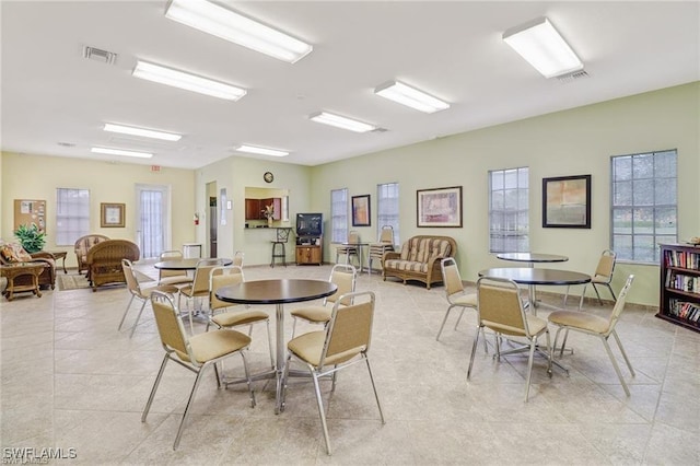 dining space featuring visible vents and light tile patterned floors