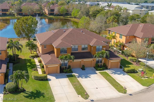 drone / aerial view featuring a water view and a residential view