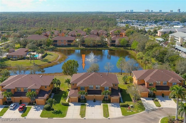 drone / aerial view featuring a water view and a residential view