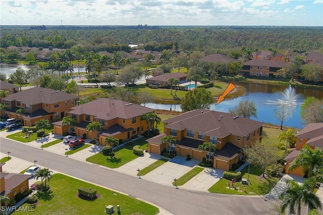 drone / aerial view with a residential view and a water view