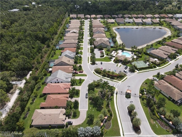 drone / aerial view with a water view and a residential view