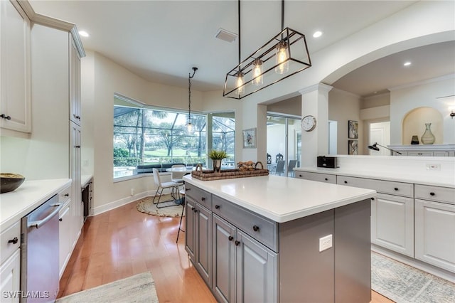 kitchen featuring gray cabinetry, visible vents, light countertops, a center island, and dishwasher