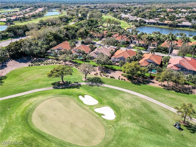 birds eye view of property featuring golf course view, a water view, and a residential view