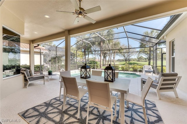 sunroom featuring plenty of natural light and a ceiling fan