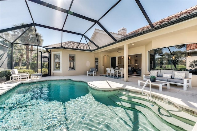 pool featuring a patio area, ceiling fan, glass enclosure, and an outdoor living space