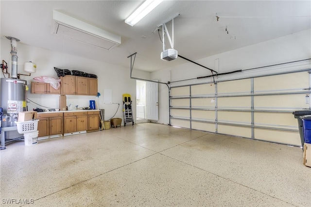 garage with gas water heater and a garage door opener