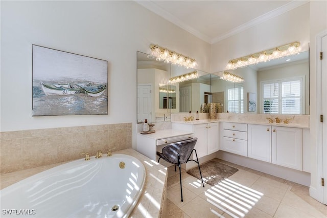 bathroom with a garden tub, vanity, crown molding, and tile patterned floors