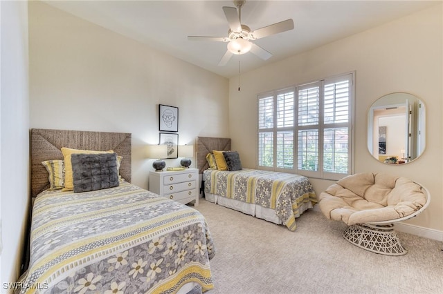 bedroom with baseboards, a ceiling fan, and light colored carpet