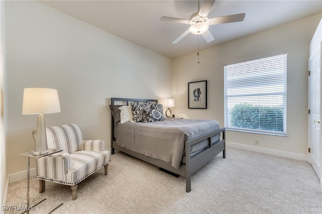 carpeted bedroom featuring a ceiling fan and baseboards