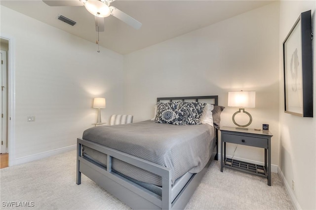 bedroom featuring ceiling fan, light colored carpet, visible vents, and baseboards