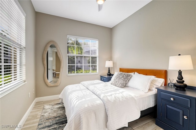 bedroom with baseboards and light wood-style flooring