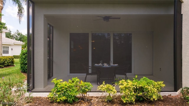 view of patio / terrace featuring a sunroom and ceiling fan